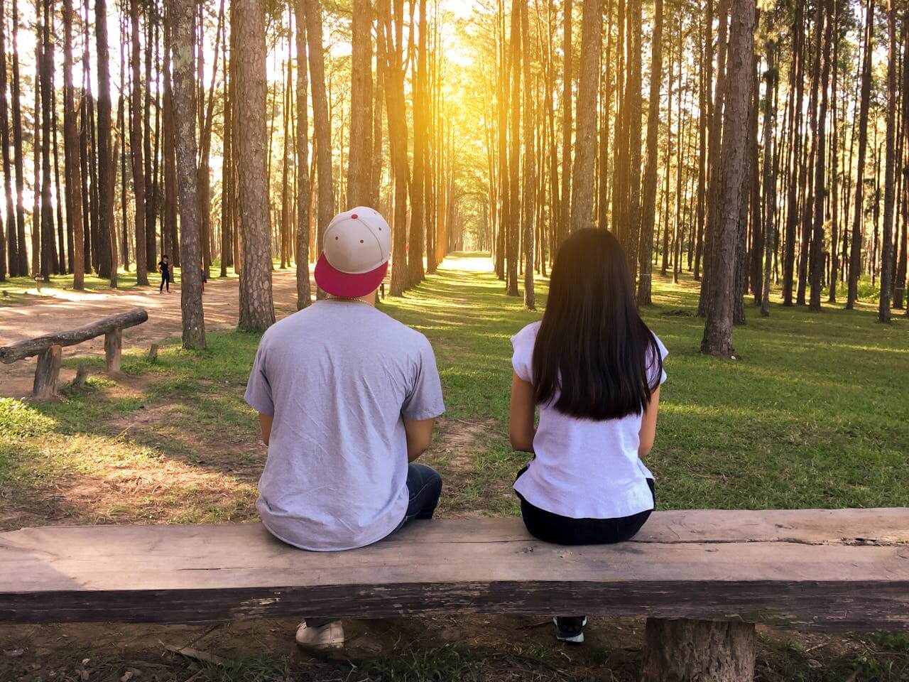 A couple with hyperhidrosis sitting on a bench at the park.