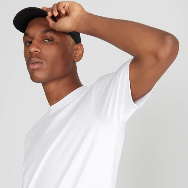 A person wearing a Social Citizen undershirt for excessive sweating.